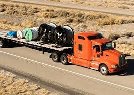 Flatbed truck delivering construction materials to job site in St. George Utah — concrete block and steel hauling